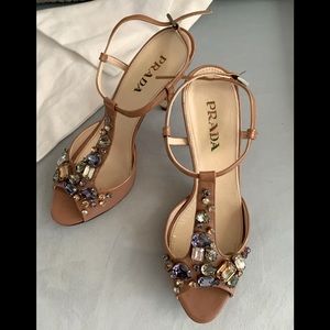 Prada woman’s tan patent heel with gemstones.